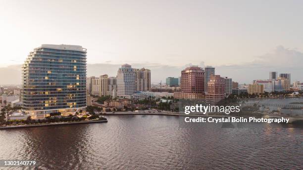 aerial drone view of downtown west palm beach, florida inlet waterfront at sunset in february of 2021 - west palm beach imagens e fotografias de stock