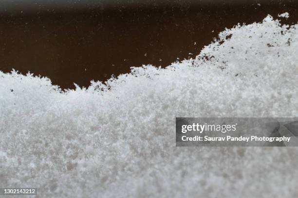 snow flakes on window - frosted flakes stock pictures, royalty-free photos & images