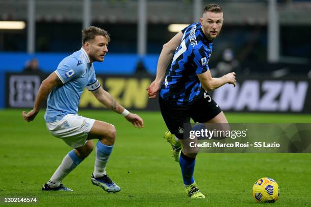 Ciro Immobile of SS Lazio competes for the ball with Milan Skriniar of FC Internazionale during the Serie A match between FC Internazionale and SS...