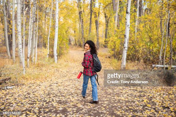 young woman walking in autumn woods - 20 20 vision bildbanksfoton och bilder