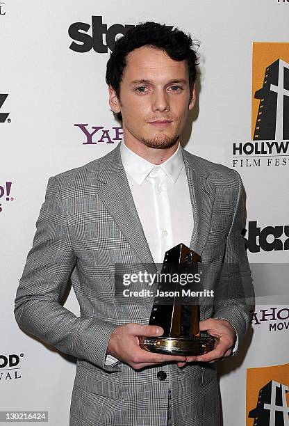 Actor Anton Yelchin poses with the Hollywood Spotlight Award backstage during the 15th Annual Hollywood Film Awards Gala Presented By Starz held at...