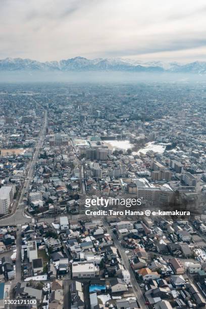 snowcapped tateyama mountains and toyama city in toyama prefecture of japan aerial view from airplane - toyama prefecture imagens e fotografias de stock