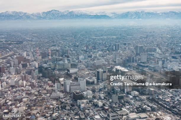 snowcapped tateyama mountains and toyama city in toyama prefecture of japan aerial view from airplane - toyama prefecture imagens e fotografias de stock