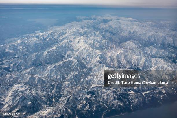 snowcapped hakuba mountain range and tateyama mountains in toyama and nagano prefectures of japan aerial view from airplane - toyama prefecture stock-fotos und bilder