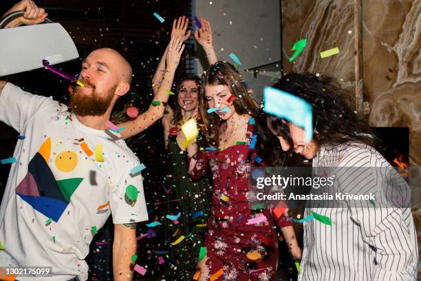 group of friends having fun with confetti at home. - christmas cool attitude stock pictures, royalty-free photos & images