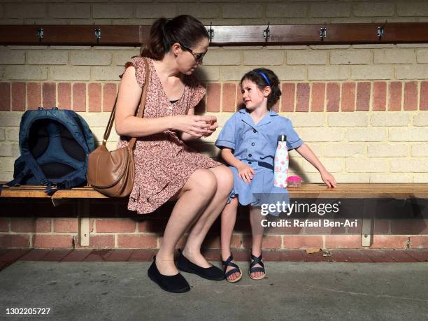 mother talking to her young daughter that is afraid to go to school - first day of school australia stock pictures, royalty-free photos & images
