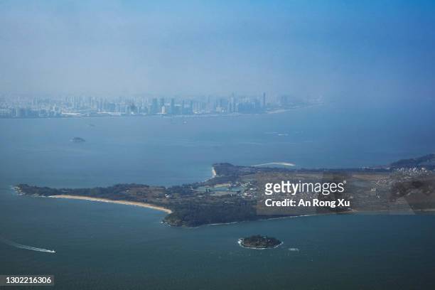 View of the South China Sea between the city of Xiamen in China, in the far distance, and the islands of Kinmen in Taiwan, in the foreground, on...