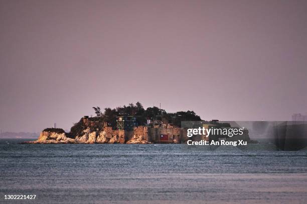 An Island that lies inside Taiwan's territory is seen with the Chinese city of Xiamen in the background on February 04, 2021 off the coast of Lieyu,...