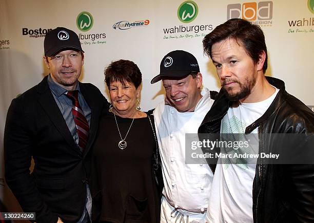 Donnie Wahlberg, their mother Alma Elaine Wahlberg, chef Paul Wahlberg and Mark Wahlberg attend the grand opening of Wahlburgers on October 24, 2011...