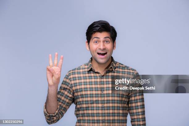 portrait of young man student, stock photo - three fingers stock pictures, royalty-free photos & images