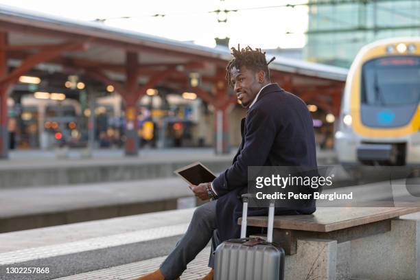 man at a train station - train vehicle stock pictures, royalty-free photos & images