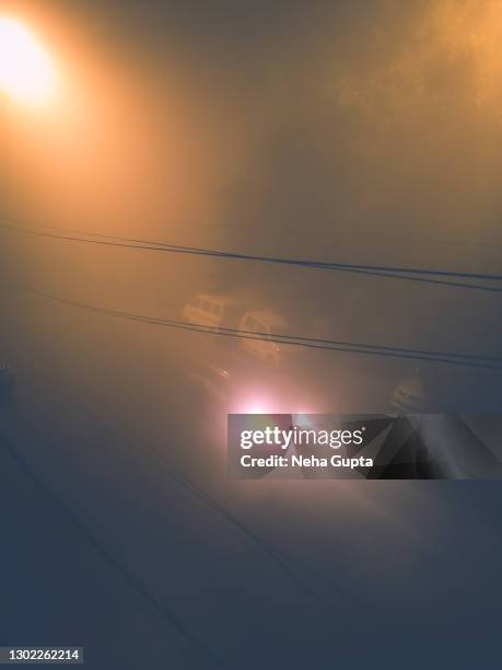 car driving - misty night during the winter season, new delhi, india. - yellow light stock pictures, royalty-free photos & images