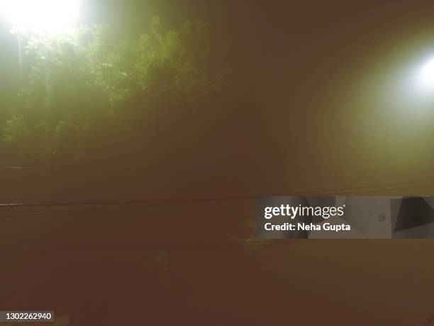 an empty street - misty night during the winter season, new delhi, india - new flash stock pictures, royalty-free photos & images