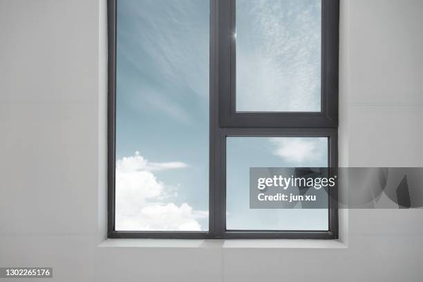 the blue sky and white clouds outside the glass window - open sky stockfoto's en -beelden