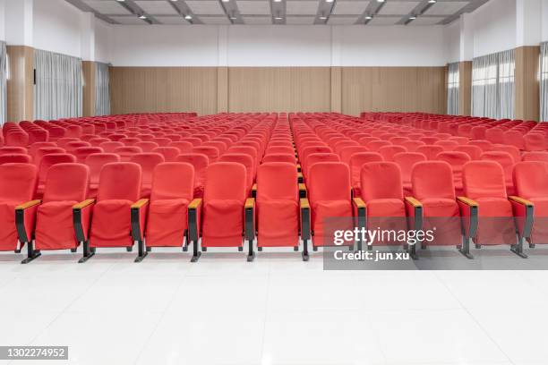 the spacious, bright conference hall is lined with red chairs - lecture hall bildbanksfoton och bilder