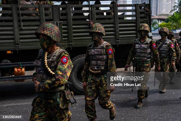 Myanmar military soldiers stand guard after arriving overnight with armoured vehicles on February 15, 2021 near the Central Bank in Yangon, Myanmar....