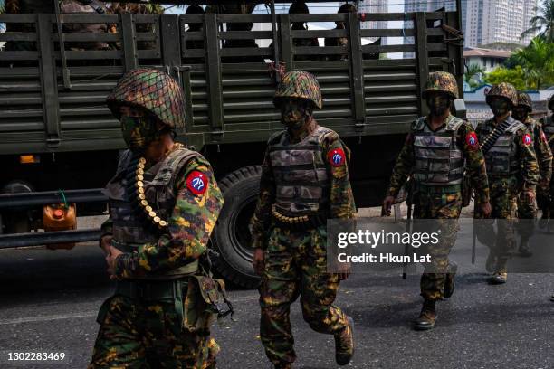 Myanmar military soldiers stand guard after arriving overnight with armoured vehicles on February 15, 2021 near the Central Bank in Yangon, Myanmar....