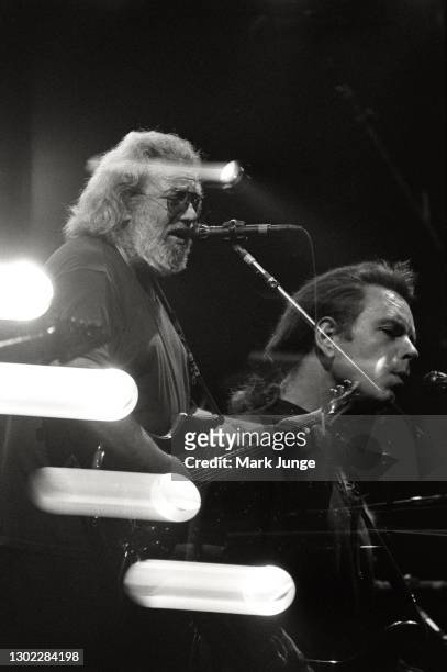 Singer-songwriter Jerry Garcia plays lead guitar while Bob Weir plays rhythm guitar during a Grateful Dead concert at McNichols Sports Arena on...