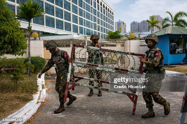 Myanmar military soldiers who arrived to guard the Central Bank overnight place barbed wire barricades on February 15, 2021 in Yangon, Myanmar. The...