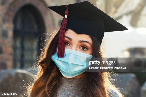 graduate girl wearing a protective face mask - medical school graduation stock pictures, royalty-free photos & images