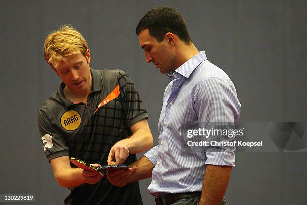 Christian Suess shows Wladimir Klitschko tips playing table tennis during the meeting of table tennis professional and German national player...