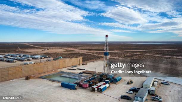 drone view of an oil or gas drill fracking rig pad with beautiful cloud filled sky - west texas stock pictures, royalty-free photos & images