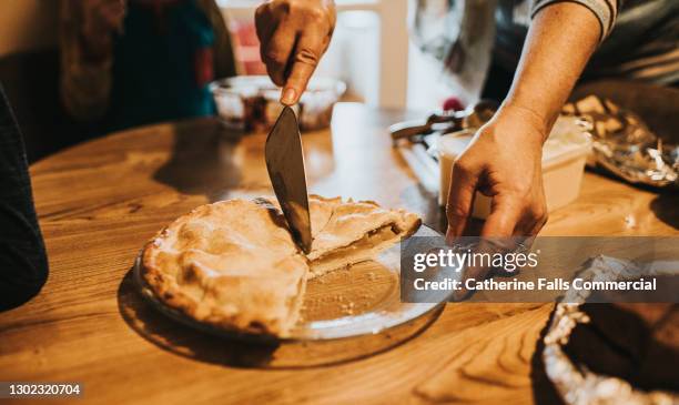 woman cuts a slice of warm apple pie - pie bildbanksfoton och bilder