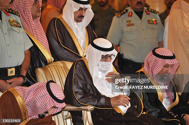 Ailing Saudi King Abdullah bin Abdel Aziz wears a surgical mask as he prays alongside family members during the funeral of his brother, the late...