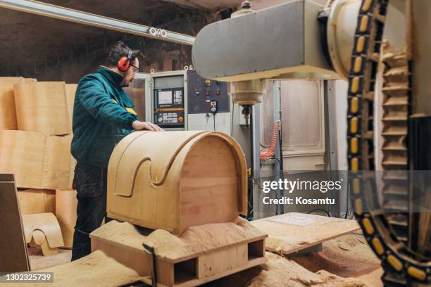 while wearing proper ppe, carpenter turning on drilling cnc machine on the switchboard - cnc turning stock pictures, royalty-free photos & images