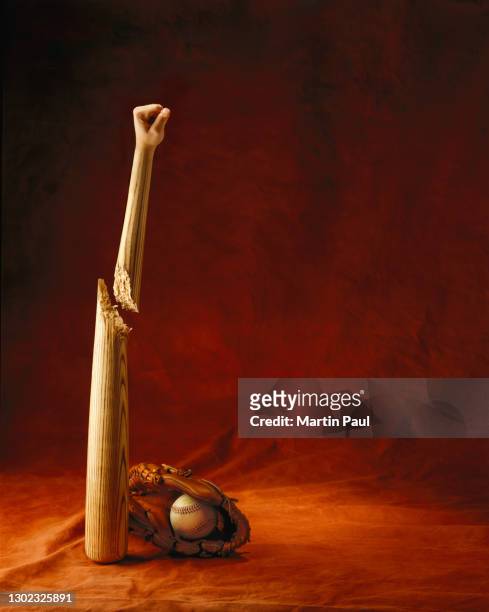 photo illustration of fist grafted onto baseball bat - sports bat stock pictures, royalty-free photos & images