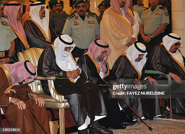 Ailing Saudi King Abdullah bin Abdel Aziz wears a surgical mask as he prays alongside family members during the funeral of his brother, the late...