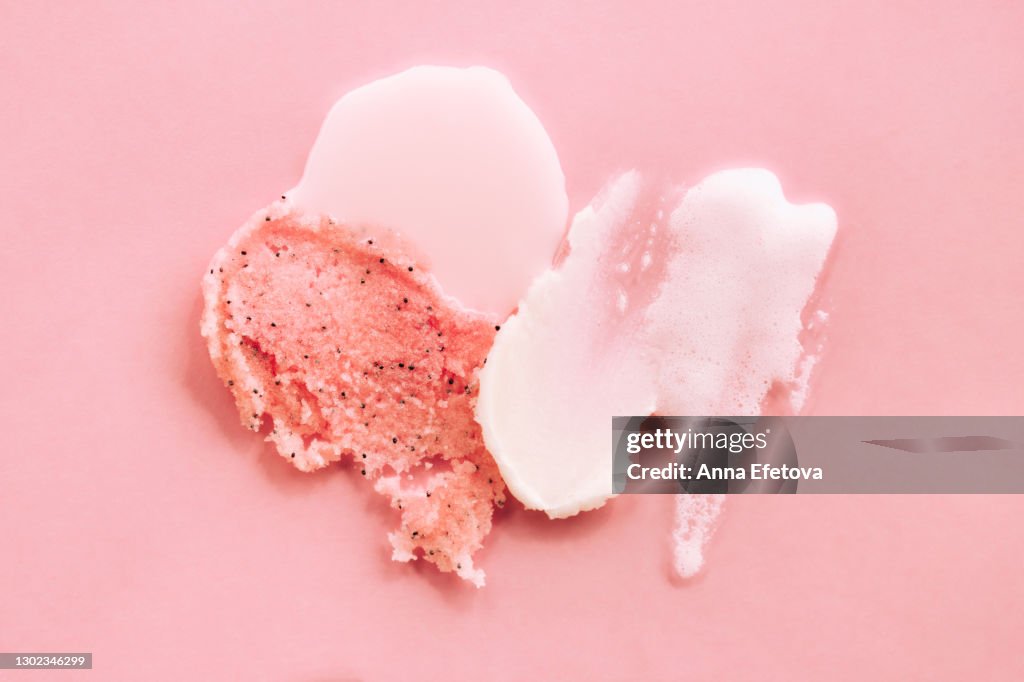 Set of abstract smears of shower gel, cream and scrub on pink background. Trendy products of the year. Health and wellness concept