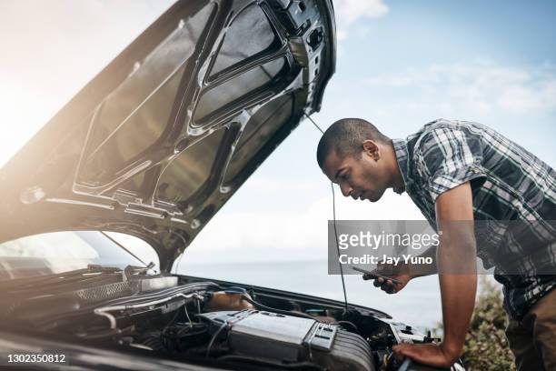 looking at the engine to see what's the cause - car hood stock pictures, royalty-free photos & images