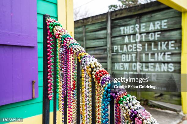 The hand rail of a home in the Bywater is wrapped with Mardi Gras beads on February 15, 2021 in New Orleans, Louisiana. Due to the COVID-19 pandemic...