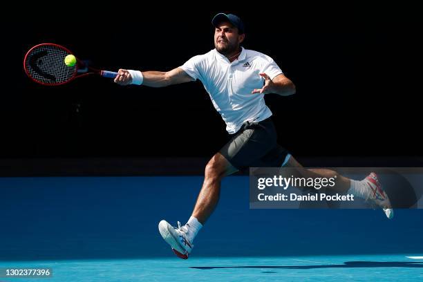 Aslan Karatsev of Russia plays a forehand in his Men's Singles Quarterfinals match against Grigor Dimitrov of Bulgaria during day nine of the 2021...