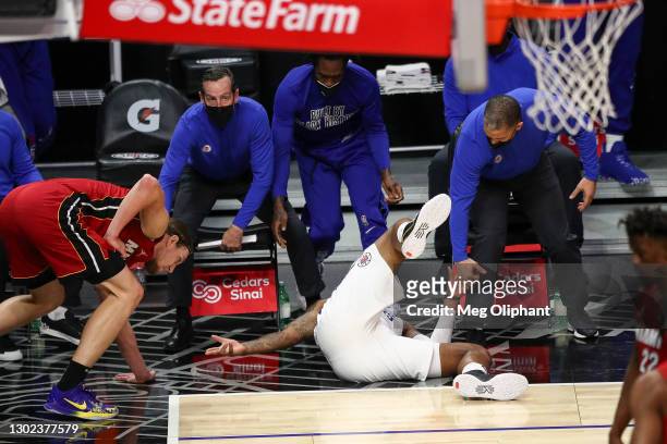 Marcus Morris Sr. #8 of the LA Clippers falls after making a three point basket while being fouled by Kelly Olynyk of the Miami Heat at Staples...