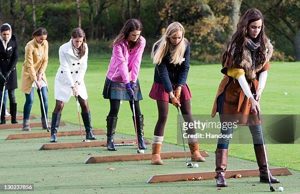 In this handout provided by Miss World Ltd, Miss World 2011 participants are given a golf lesson on the Gleneagles golf course on October 25, 2011 in...