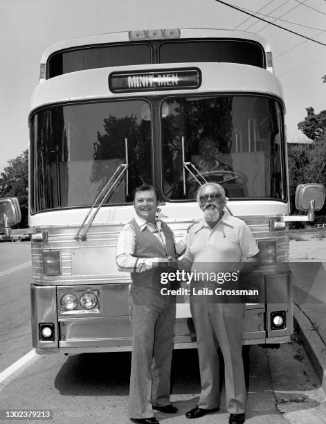 Country singer songwriter Stonewall Jackson poses in front of his tour bus shaking hands with producer Bob Neal of the William Morris Agency 1977 in...