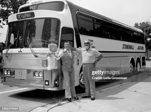 Country singer songwriter Stonewall Jackson poses in front of his tour bus with producer Bob Neal of the William Morris Agency 1977 in Nashville,...