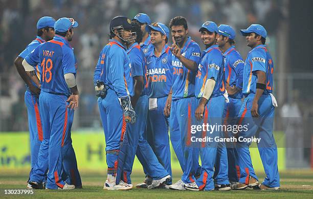 Praveen Kumar of India signals to Jonathan Trott of England after he's dismissed by Ravindra Jadeja during the 5th One Day International between...