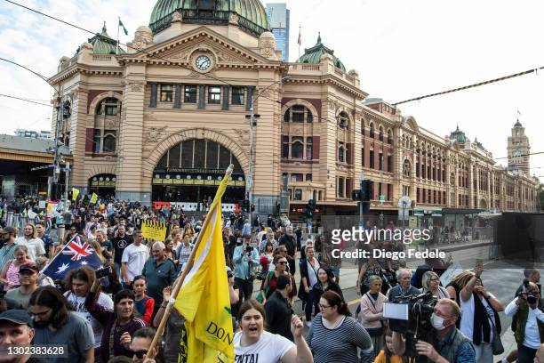 Anti lockdown protesters are seen leaving Flinders Street Station to start their march of protest, following the announce of the lockdown on February...