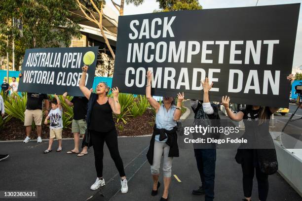 Anti lockdown protesters are seen holding signs in front of the Rod Lavern Arena, following the announce of the lockdown on February 12, 2021 in...