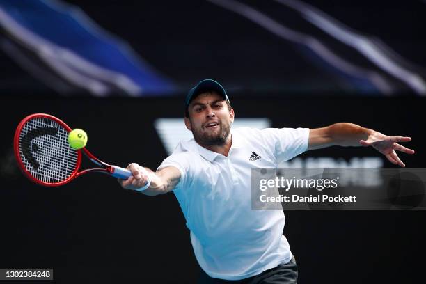 Aslan Karatsev of Russia plays a forehand in his Men's Singles Quarterfinals match against Grigor Dimitrov of Bulgaria during day nine of the 2021...