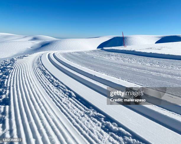 cross-country ski track in snowy mountains - cross country skiing tracks stock pictures, royalty-free photos & images