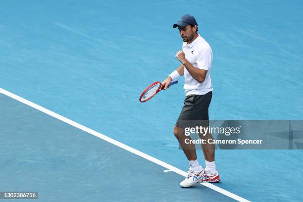 Aslan Karatsev of Russia celebrates winning match point in his Men's Singles Quarterfinals match against Grigor Dimitrov of Bulgaria during day nine...