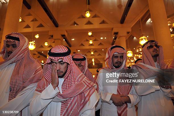 Members of the Saudi royal family attend the funeral of late Saudi Crown Prince Sultan bin Abdul Aziz at Imam Turki bin Abdullah mosque in Riyadh on...
