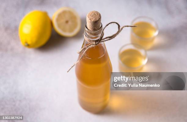 homemade lemonade in a glass bottle - essig stock-fotos und bilder