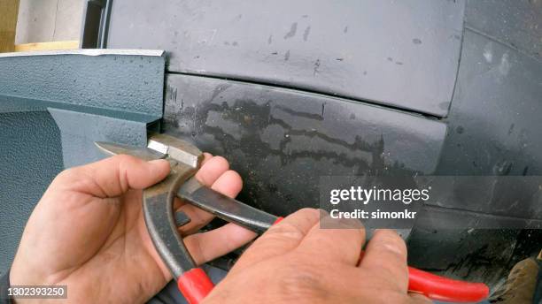 construction worker cutting roof tile - pliers stock pictures, royalty-free photos & images