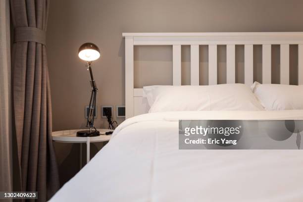 comfortable and tidy bedroom - floor lamp stock-fotos und bilder