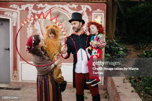 family of four dressed as the circus playing - animal tamer fotografías e imágenes de stock